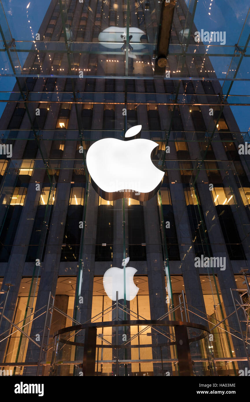 Low angle view of the front of the New York Apple store at night with the logo lit Stock Photo