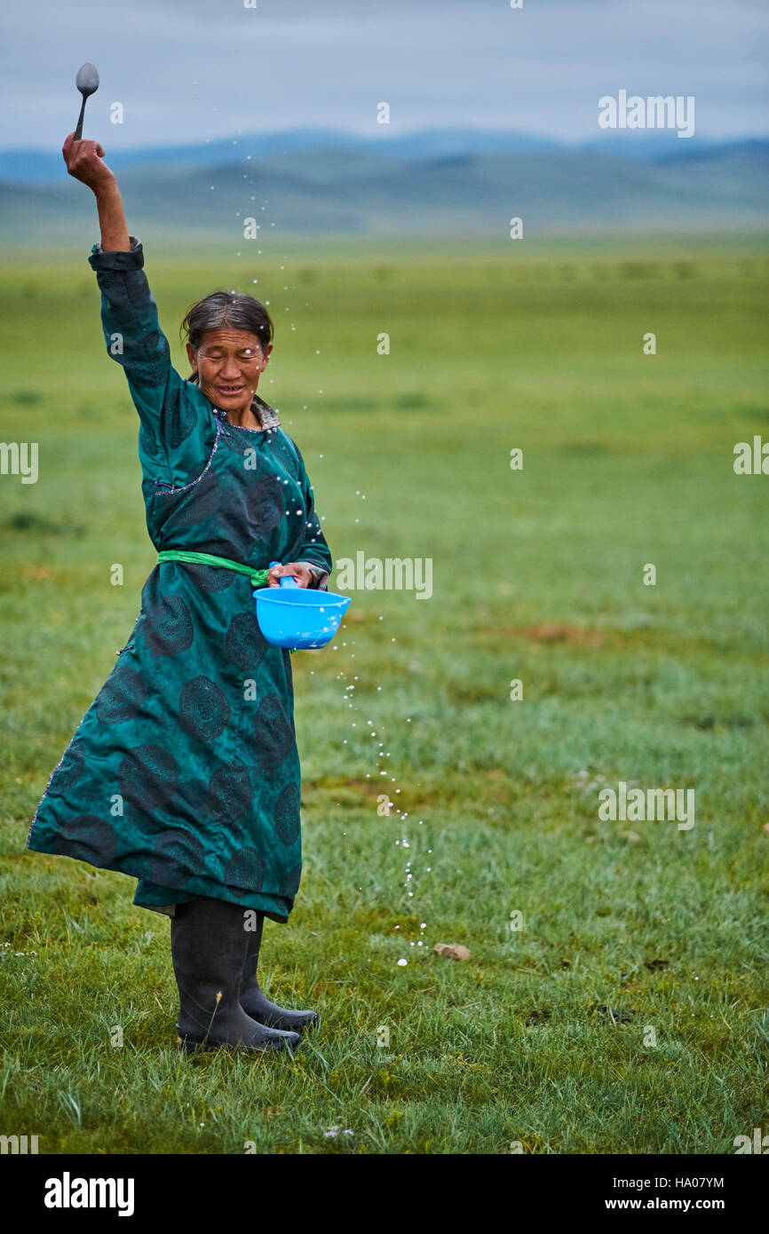 Mongolia, Arkhangai province, nomad woman making an offering to Tengri, the spirit of the sky Stock Photo