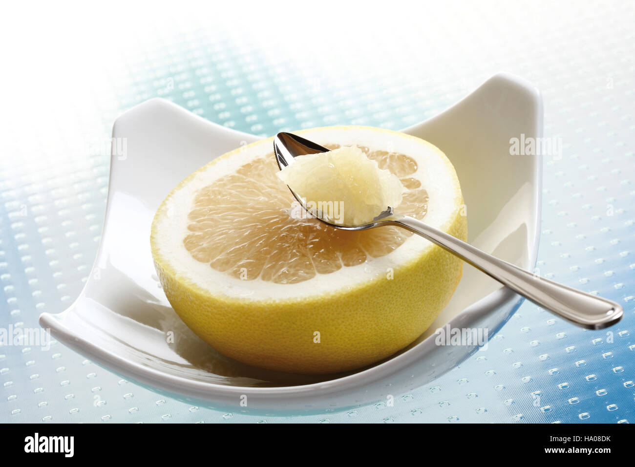 Grapefruit with a spoon Stock Photo Alamy