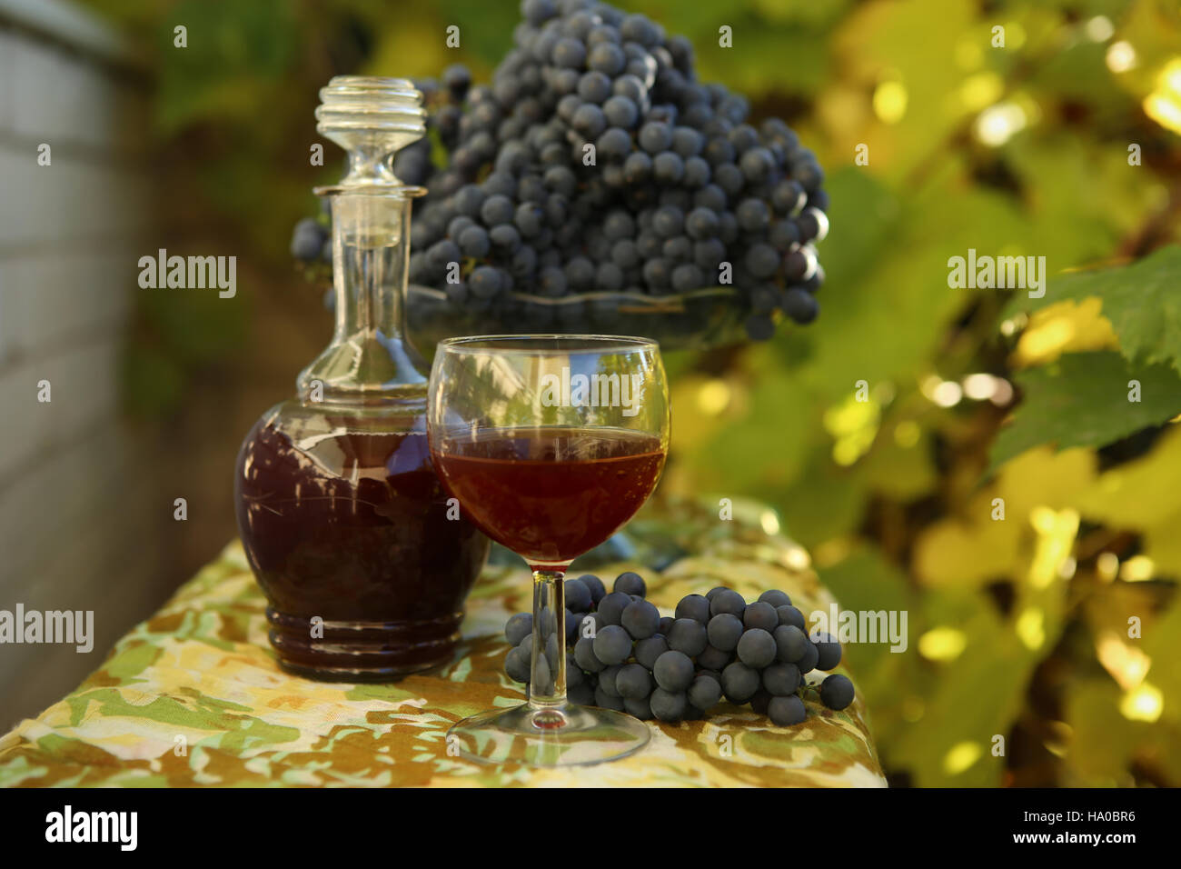 Homemade wine from grapes. Decanter, glass, grapes photographed against