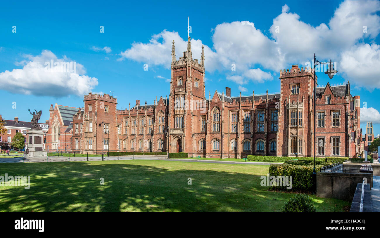 The Queen's University of Belfast with a grass lawn and a hedge in sunset light Stock Photo