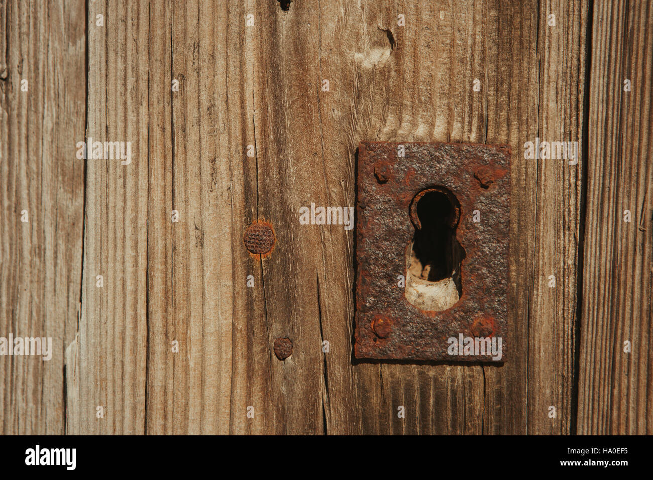 Closed rusty on an old wooden door Stock Photo - Alamy