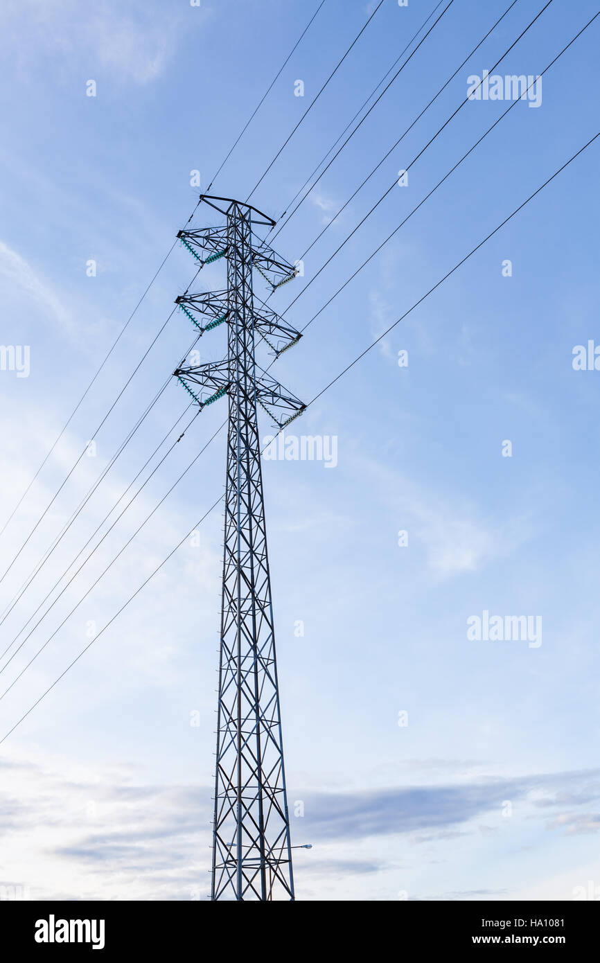 High voltage pole against blue sky Stock Photo - Alamy