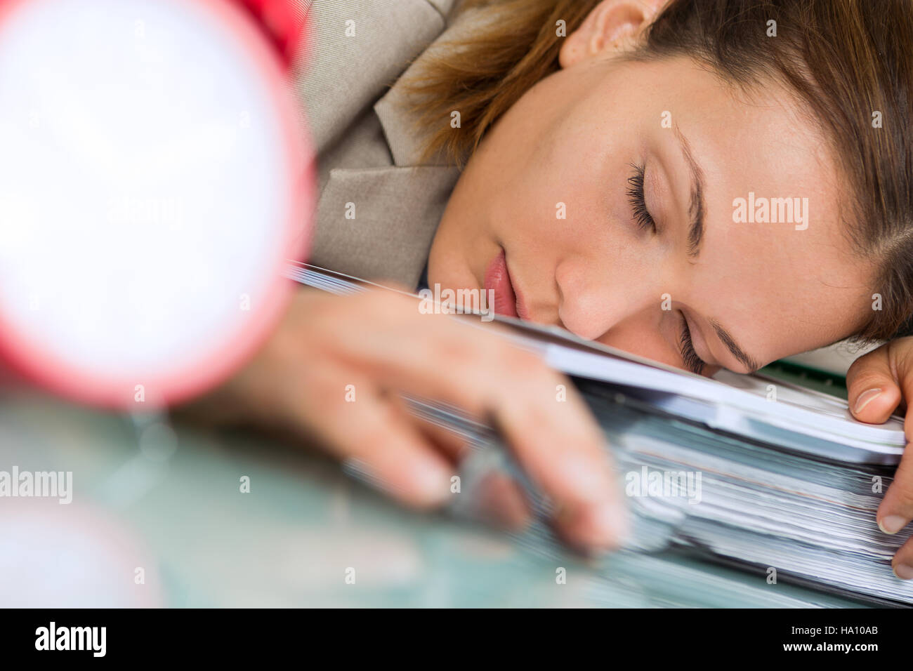 tired young businesswoman sleeping on pile of folders in office Stock ...