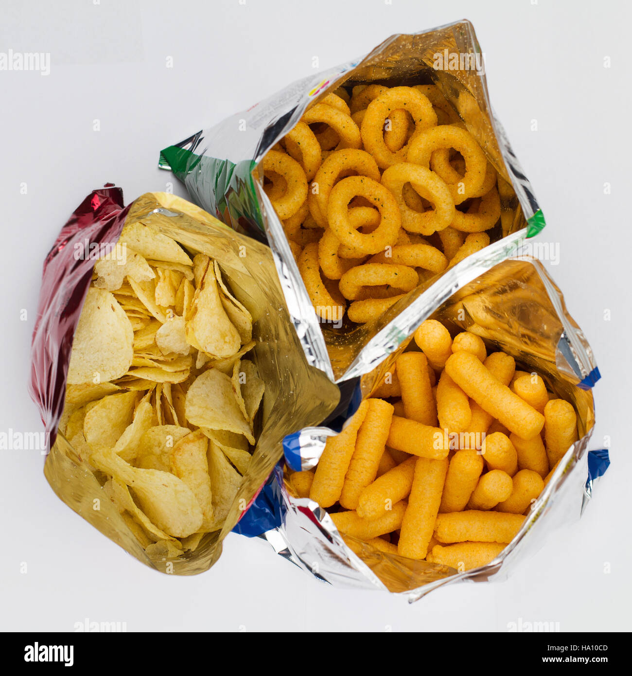 top view of three open bags of chips of different sizes, colors and