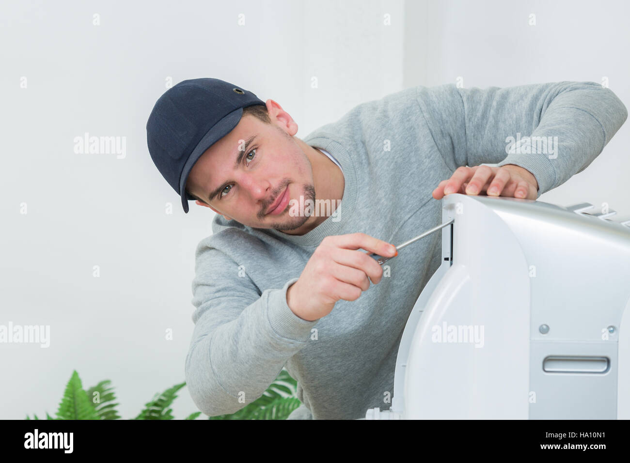 Young Technician Installing Air Conditioning System Indoors Stock Photo Young technician installing air conditioning system indoors stock photo