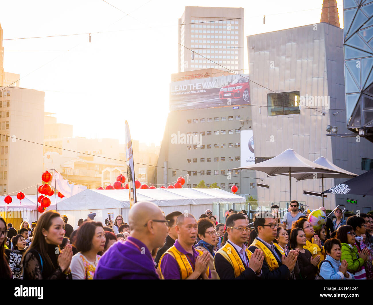 Multicultural crowd praying in Melbourne Stock Photo