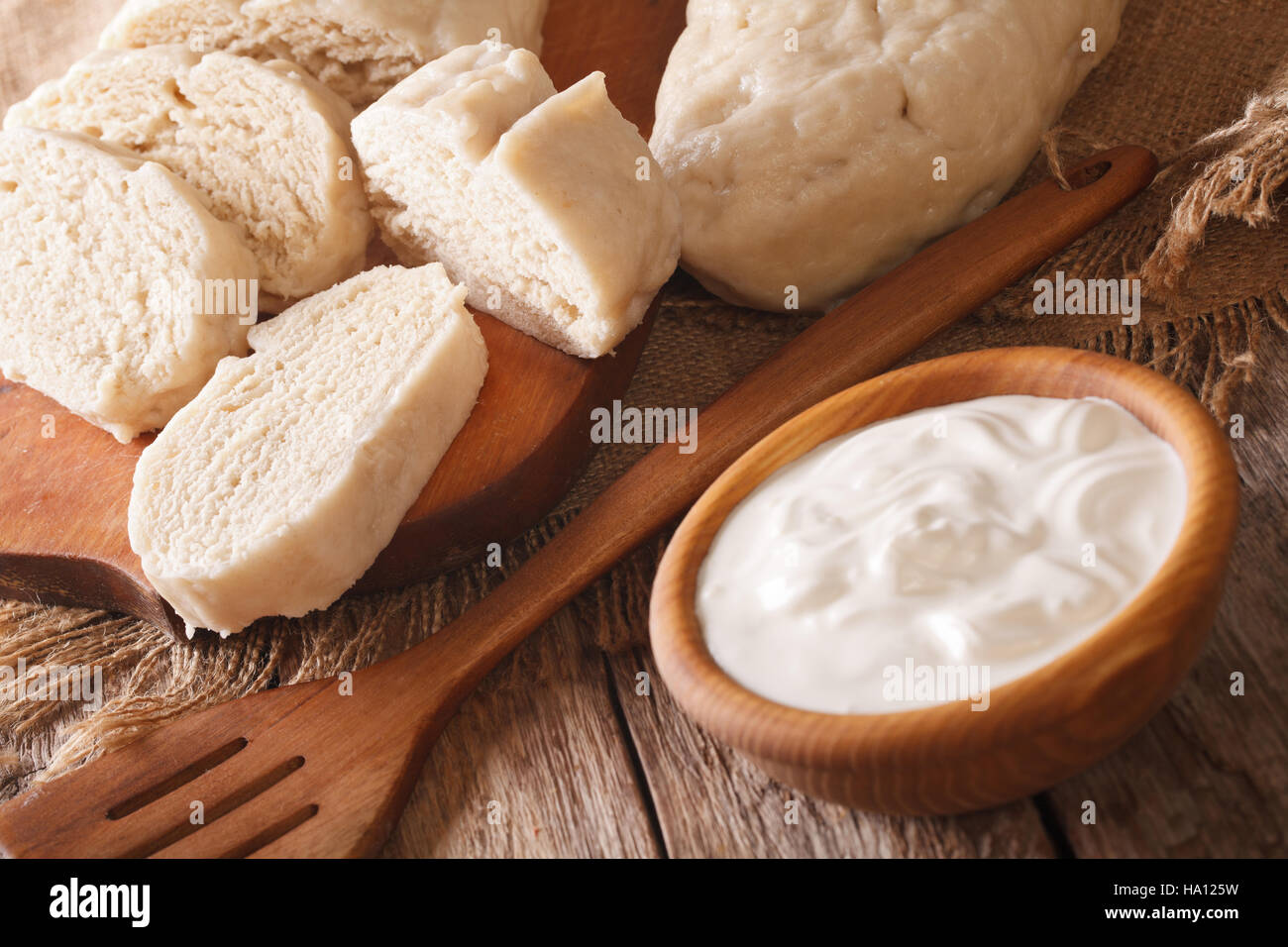 Czech sliced knedliks with sour cream close-up on the table. horizontal Stock Photo