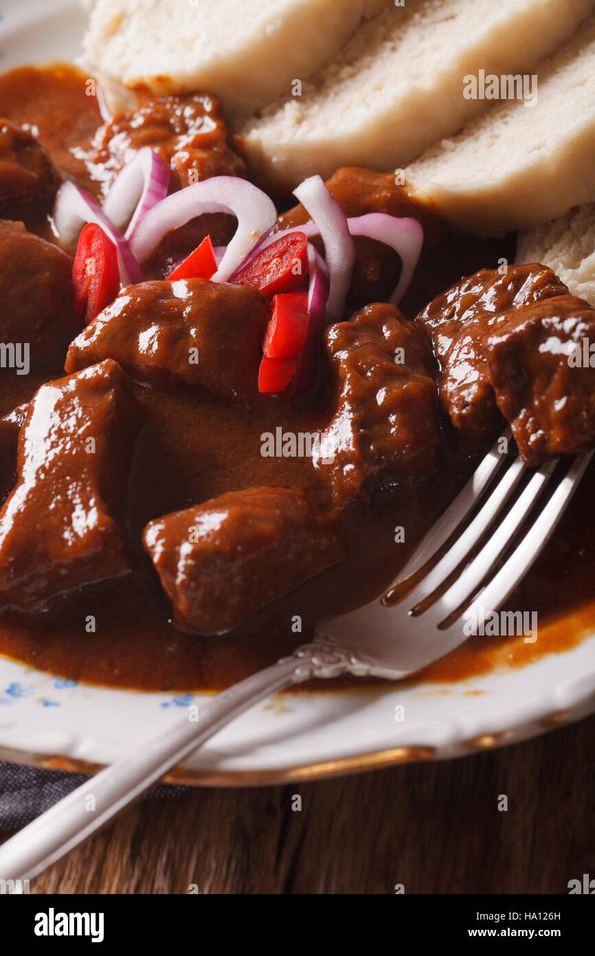 Delicious homemade hot Czech goulash macro in plate. vertical Stock Photo