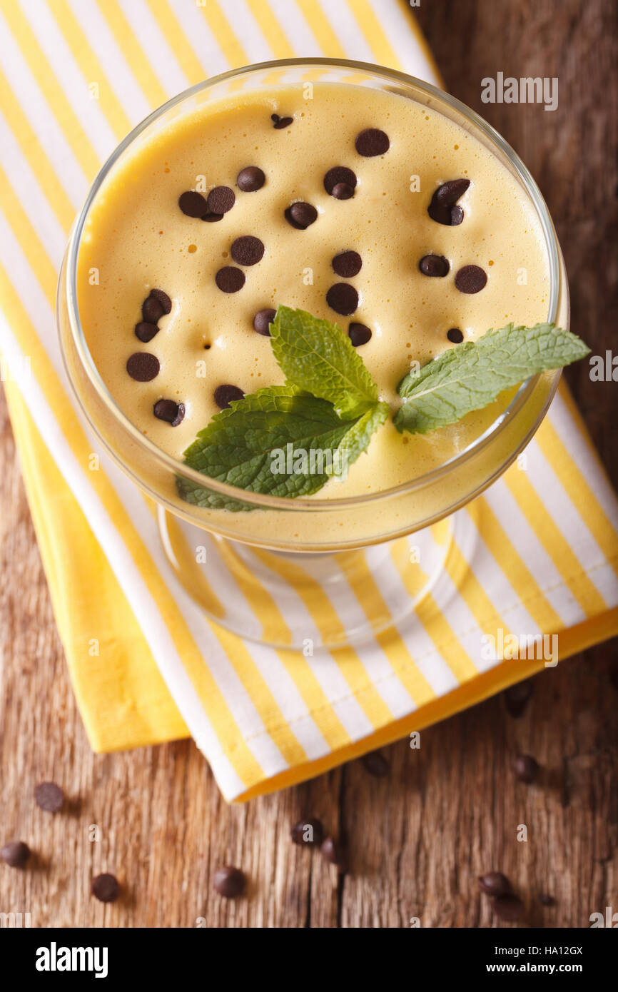 Italian dessert cream Zabaione with chocolate drops close up in a glass ...