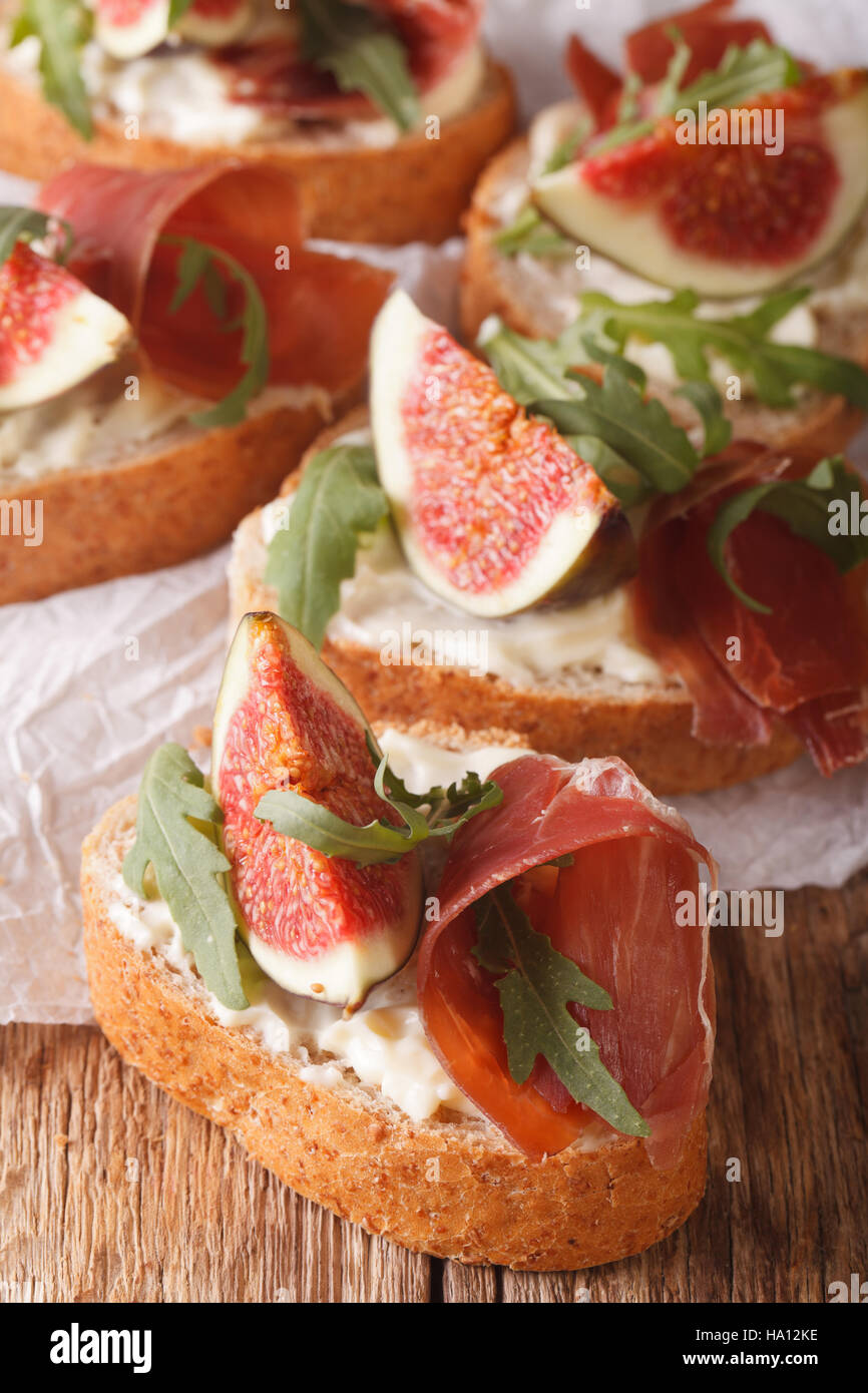 sandwich with figs, ham and cream cheese macro on the table. Vertical Stock Photo