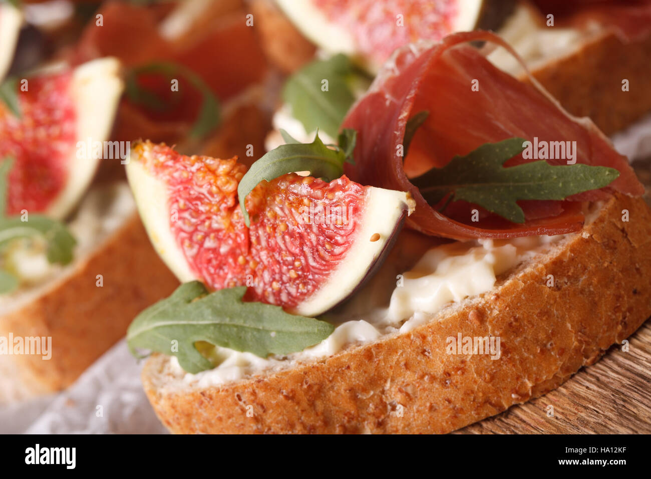 sandwich with figs, ham and cream cheese macro on the table. horizontal Stock Photo