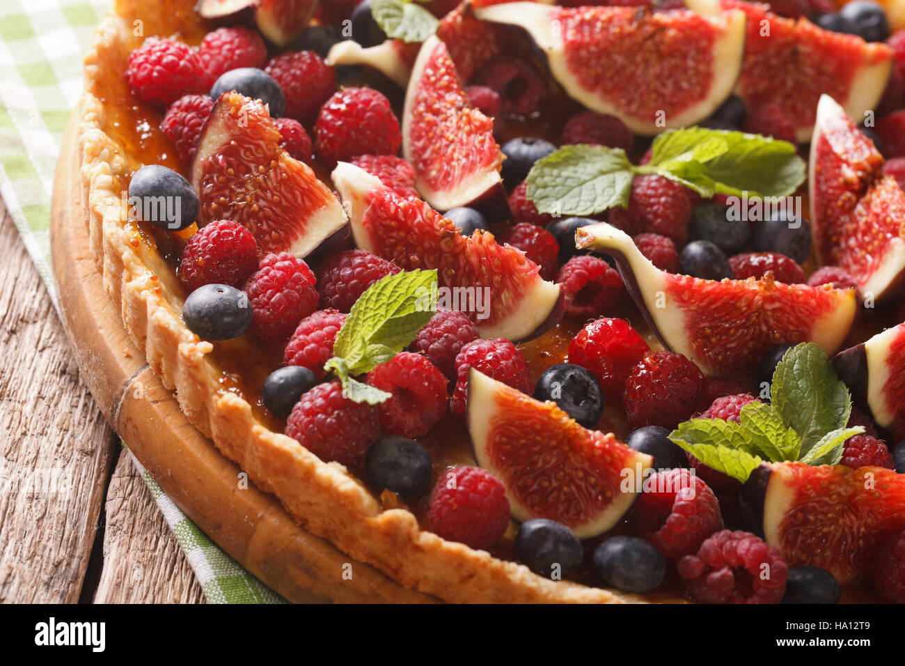 tart with figs, raspberries and blueberries macro on the table. horizontal Stock Photo