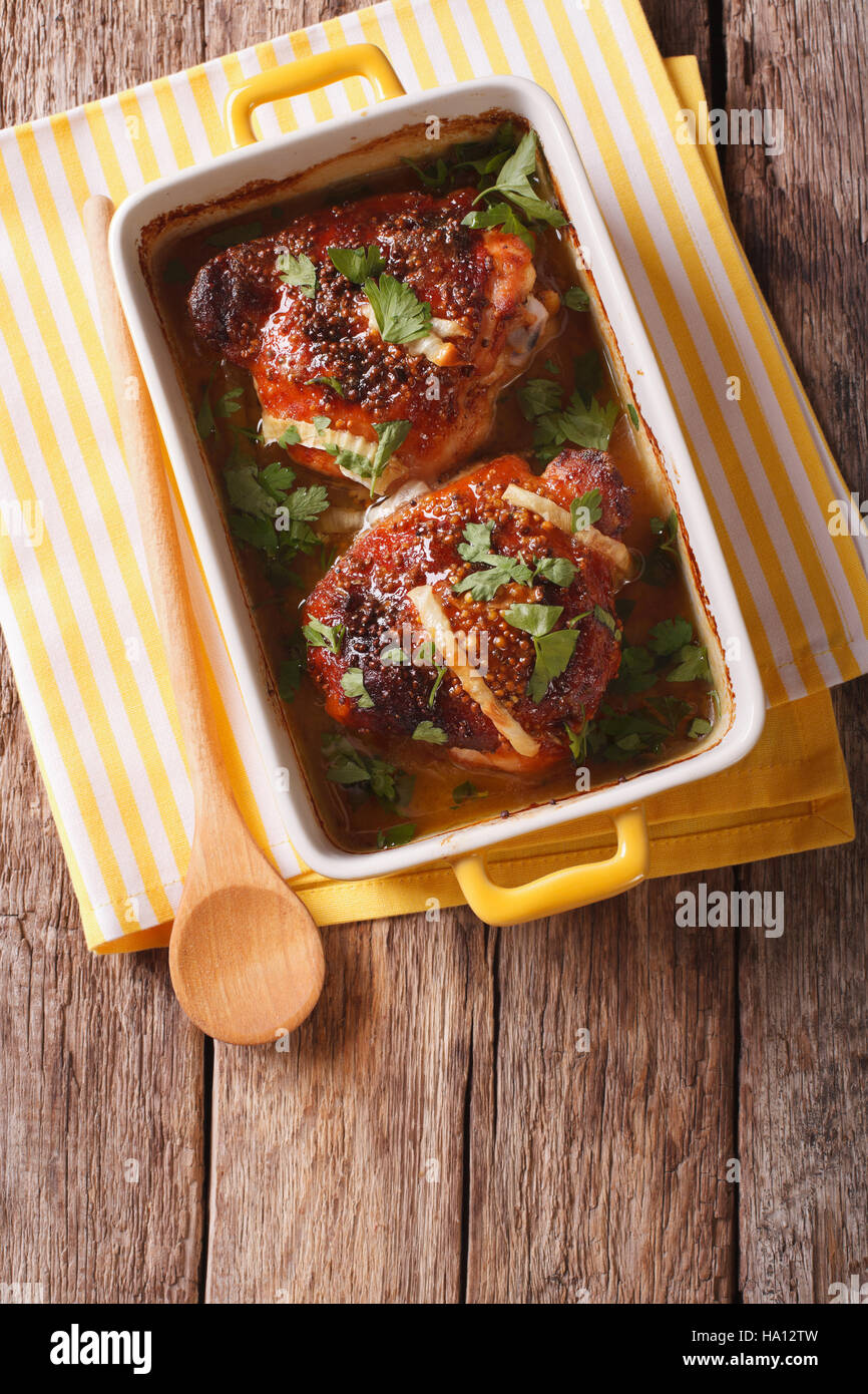 Chicken thighs with onion baked in honeymustard sauce in a dish for