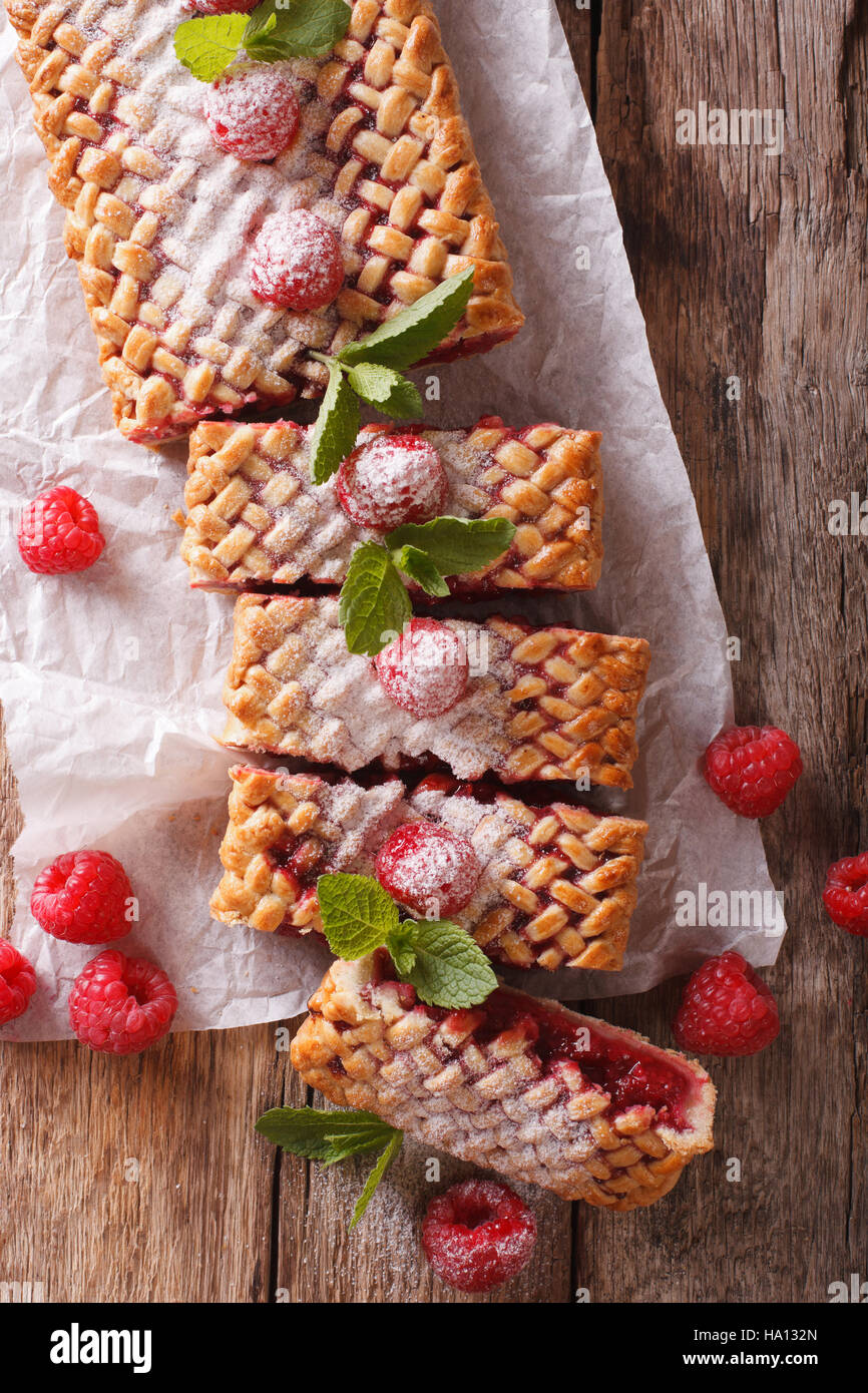 Homemade tasty raspberry pie close-up on the table. vertical view from above Stock Photo
