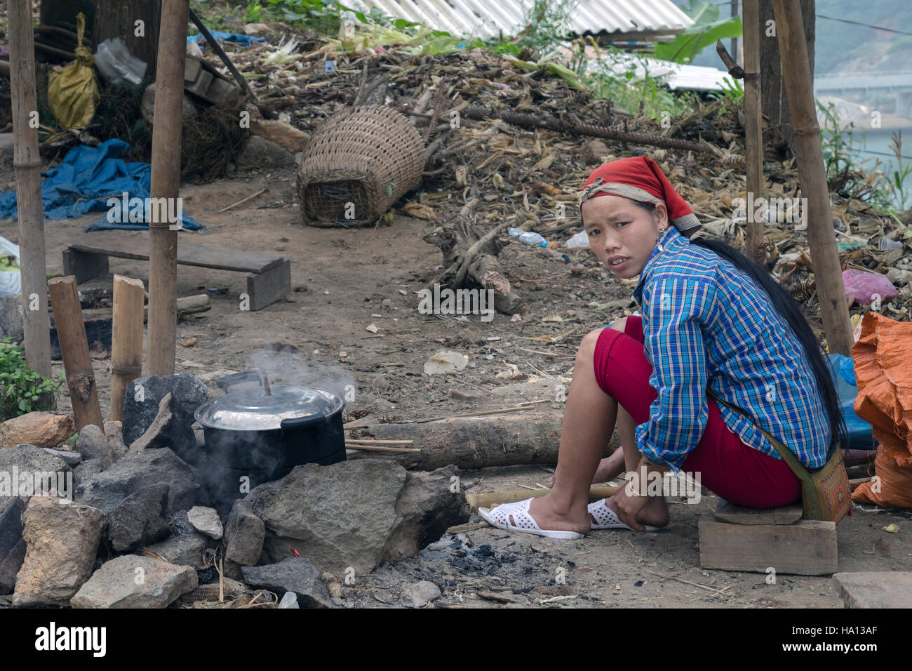 ethnic Red Dzao woman cooking on the street in Lao Cai in Sapa, Vietnam, Asia Stock Photo