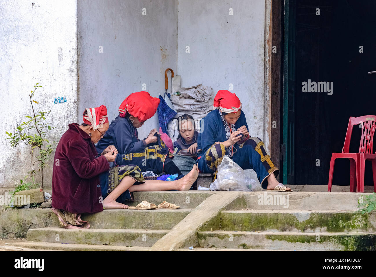 ethnic Red Dzao family sewing on the street of Ta Phin, Lao Cai in Sapa, Vietnam, Asia Stock Photo