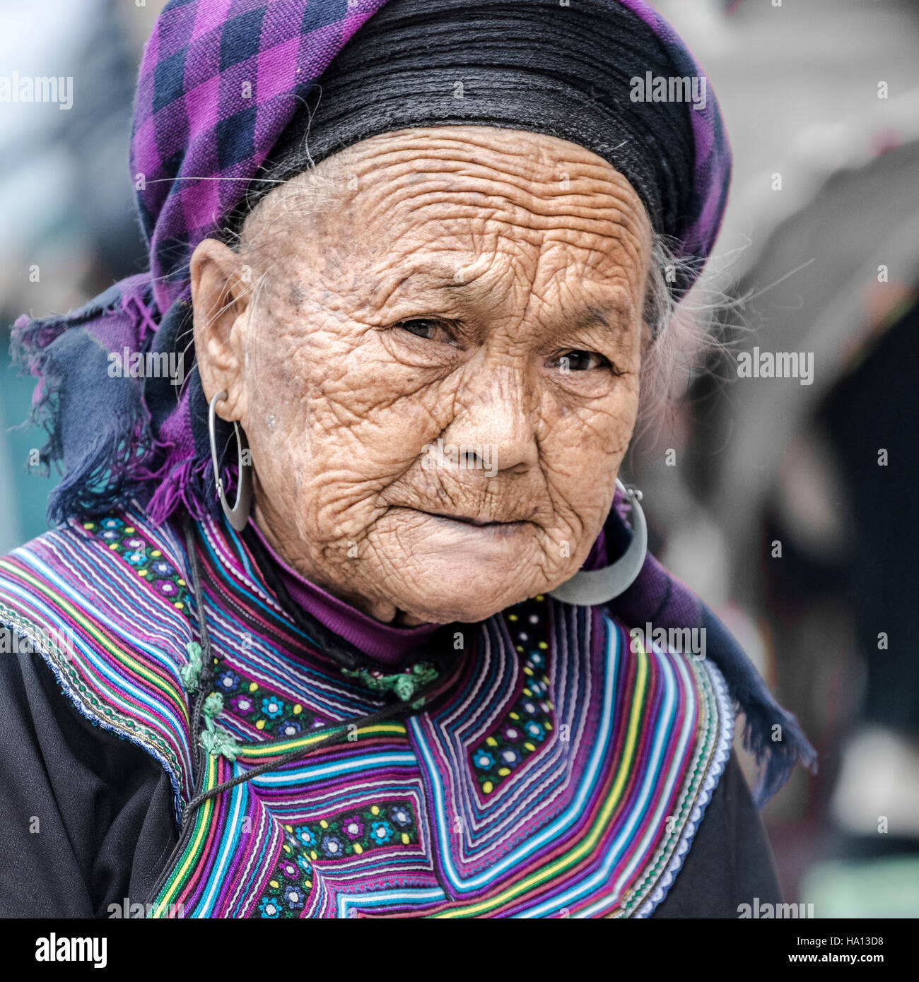 Black Hmong woman waiting for customers on the local market in Sapa, Vietnam, Asia Stock Photo