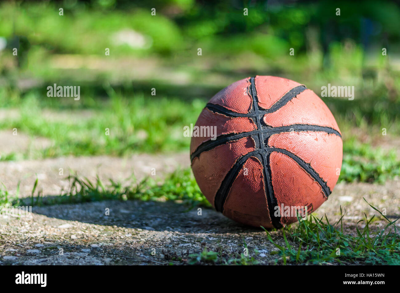 Used basketball in country playground in a sunny morning Stock Photo