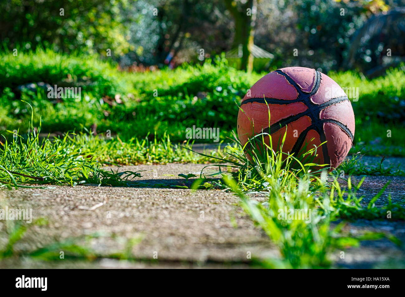 Used basketball in country playground in a sunny morning Stock Photo