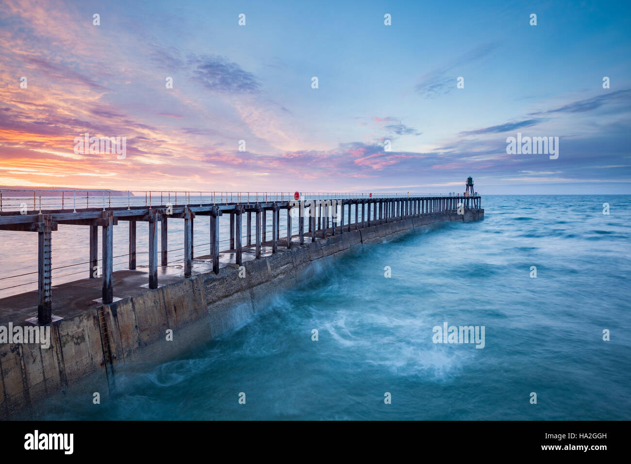 Sunset over West Pier at Whitby, North Yorkshire Stock Photo