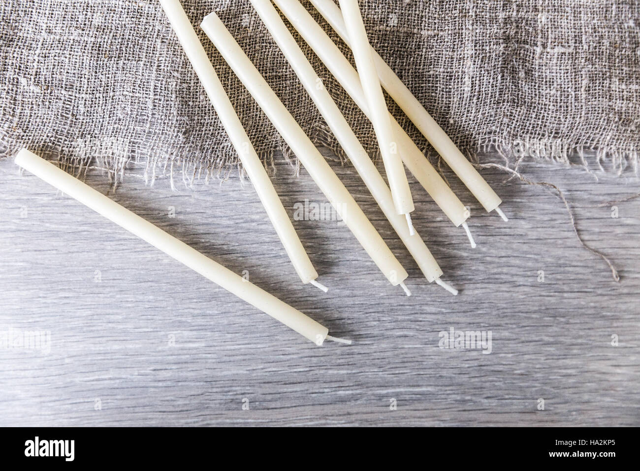 Seven birthday candles lying on table with linen Stock Photo