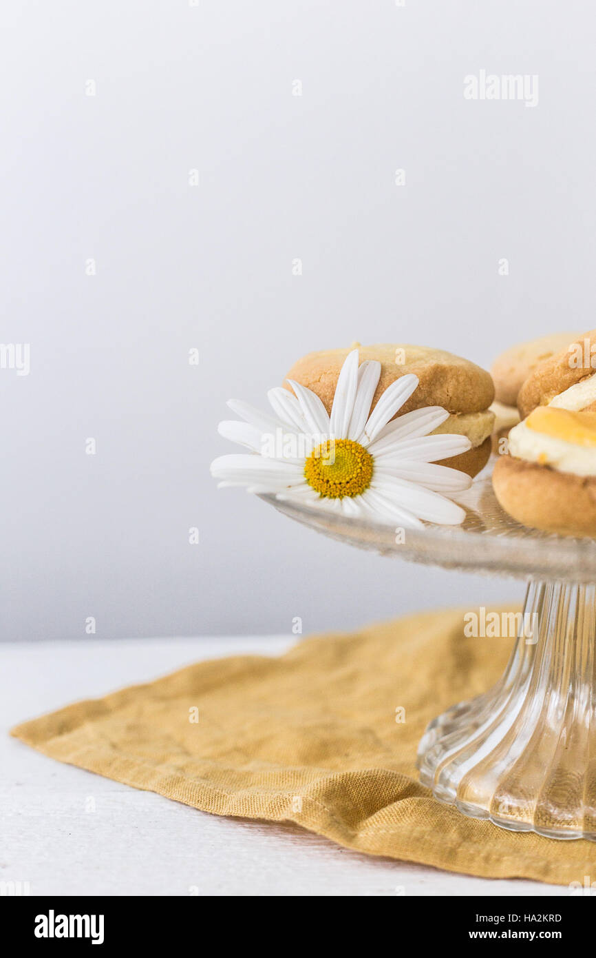 Lemon Melting Moments on a cake stand Stock Photo