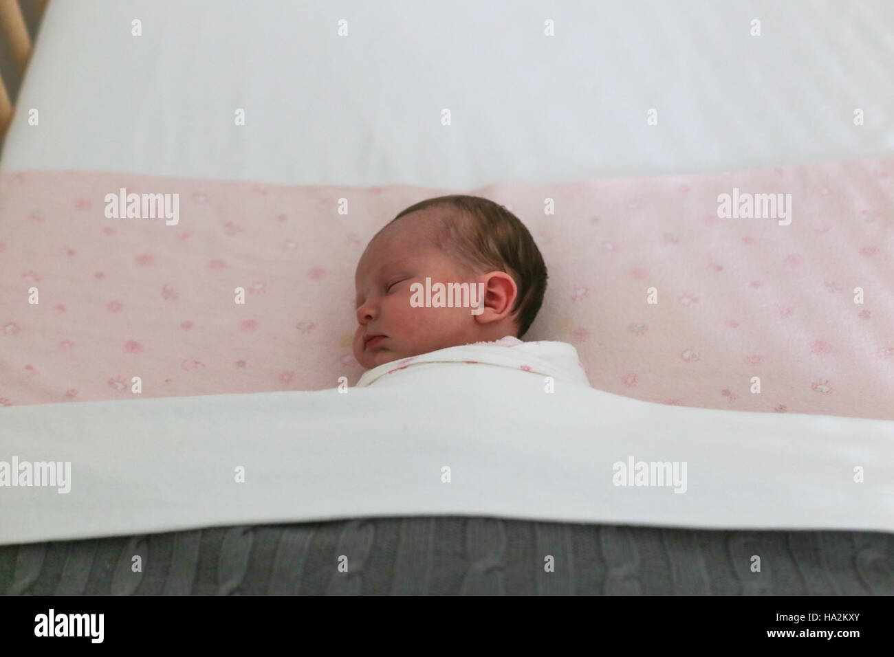 Baby girl sleeping in cot Stock Photo Alamy