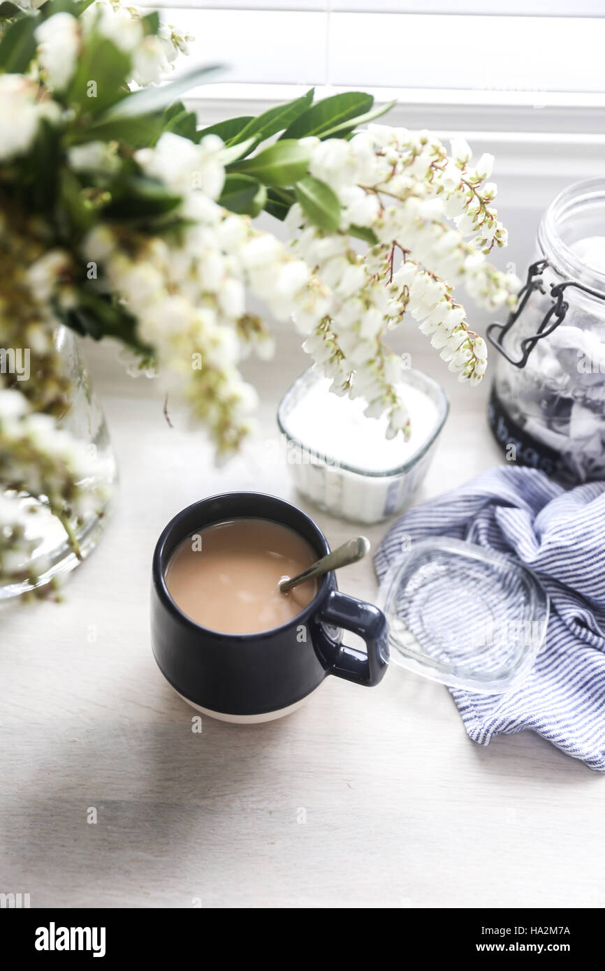 Cup of tea and vase of flowers Stock Photo
