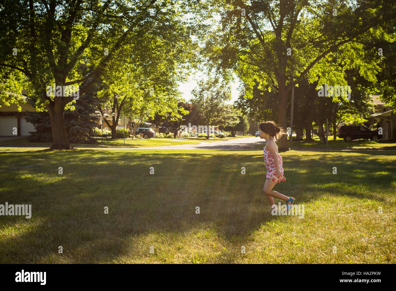 Girl playing in back yard Stock Photo