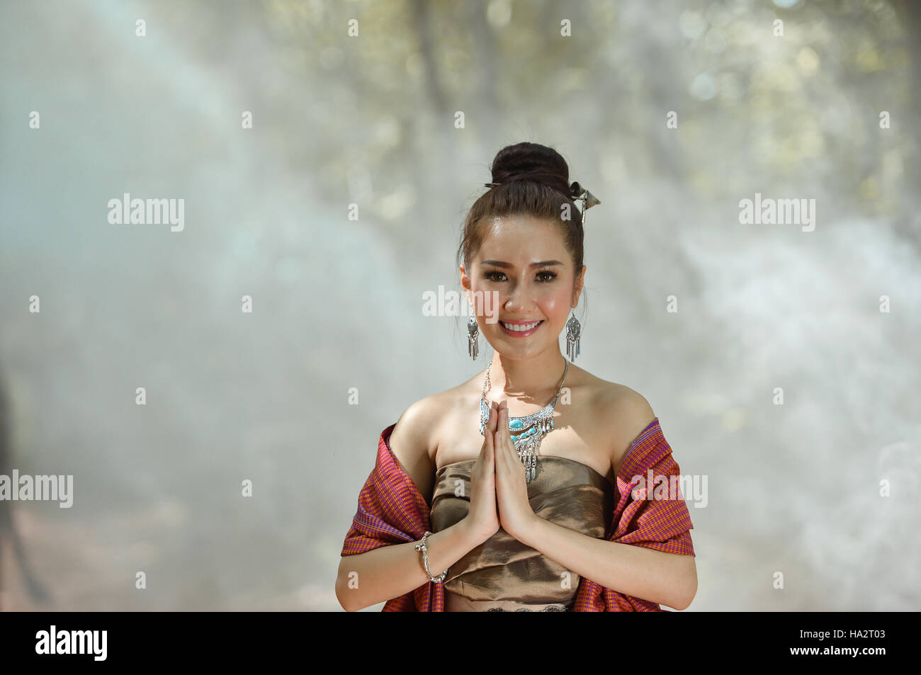 Portrait of a woman with hands in prayer position, Thailand Stock Photo