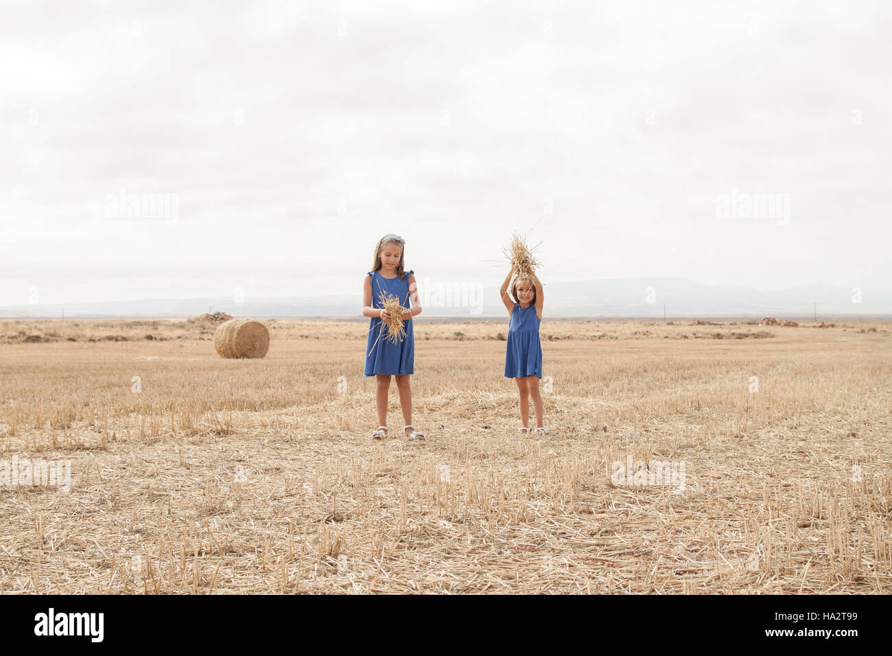 Two girls standing in a field Stock Photo