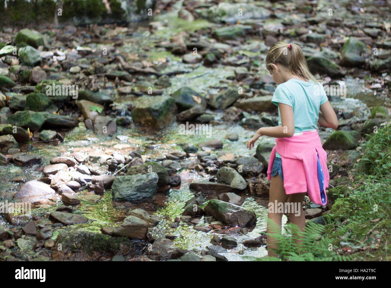 Girl standing by river Stock Photo