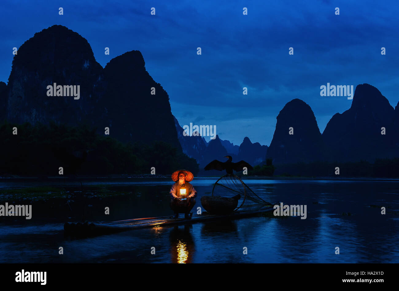 Fisherman  on raft on Li river at night, Guilin, Guangxi,  China Stock Photo