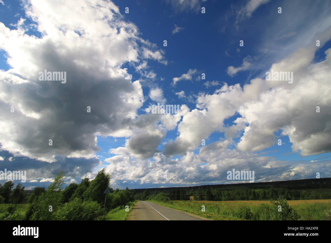 road in the field cloudy landscape Stock Photo - Alamy