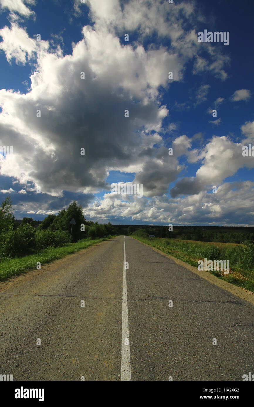 road in the field cloudy landscape Stock Photo - Alamy