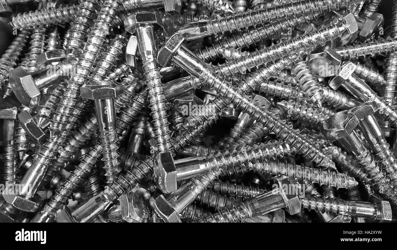 close up of shiny new screws in a pile Stock Photo