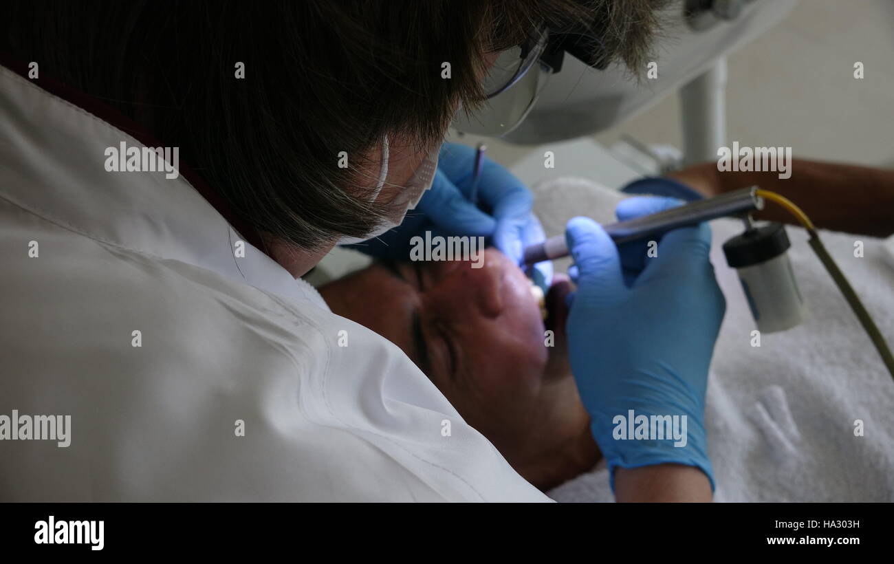Dentist And Patient During Surgery Stock Photo