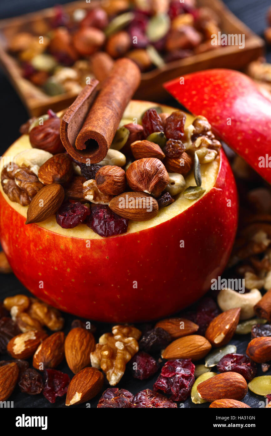 Red juicy apple with assorted nuts , raisins and cinnamon sticks Stock ...