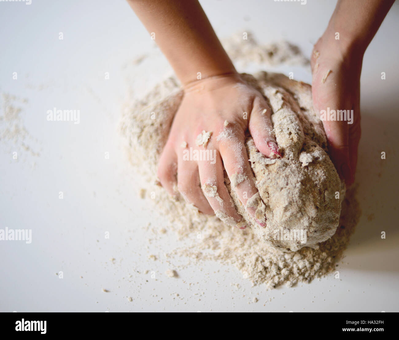Woman's hands knead dough on a table Stock Photo - Alamy