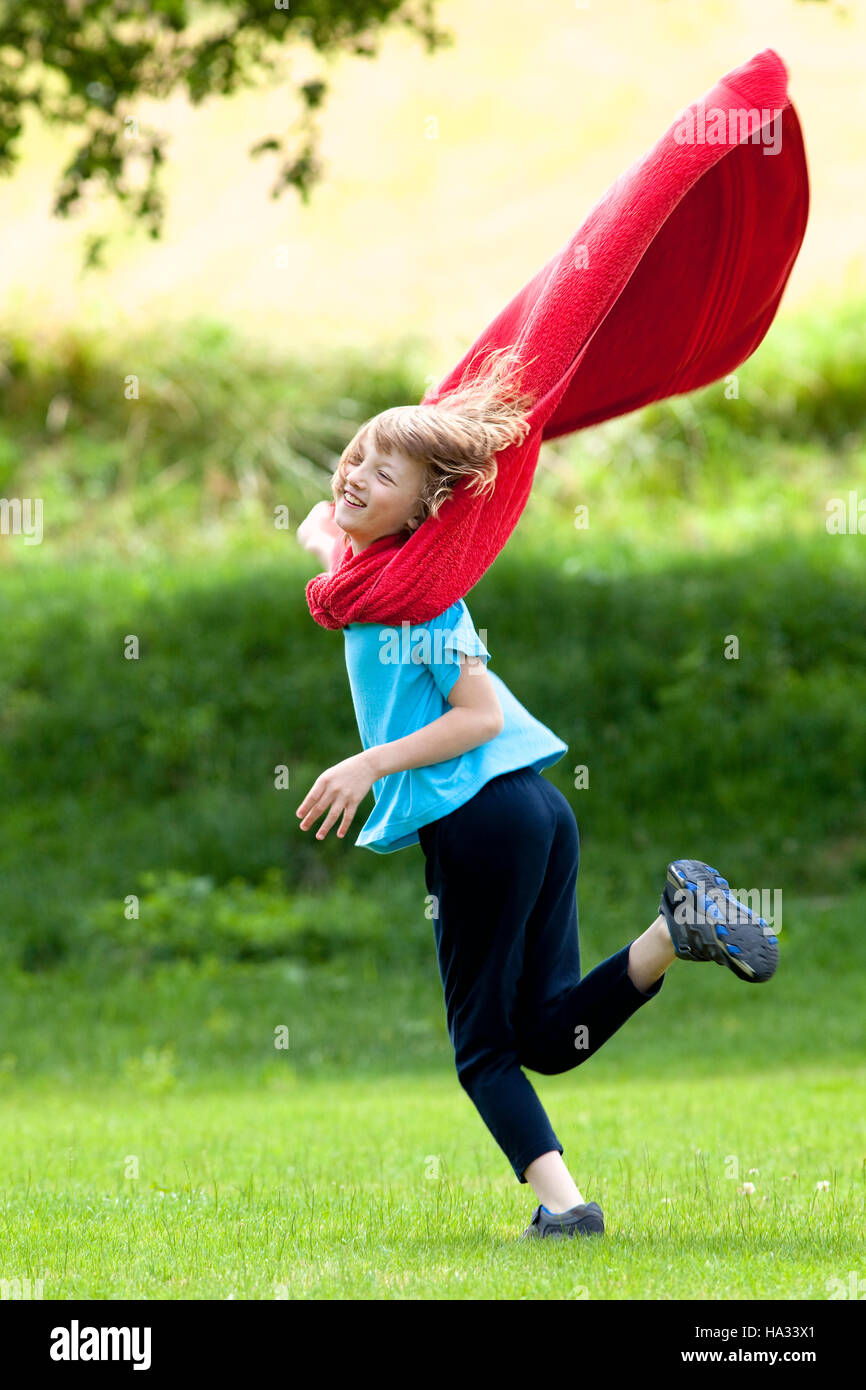 Boy Running Around in Red Towel as Superhero Cloak Stock Photo - Alamy