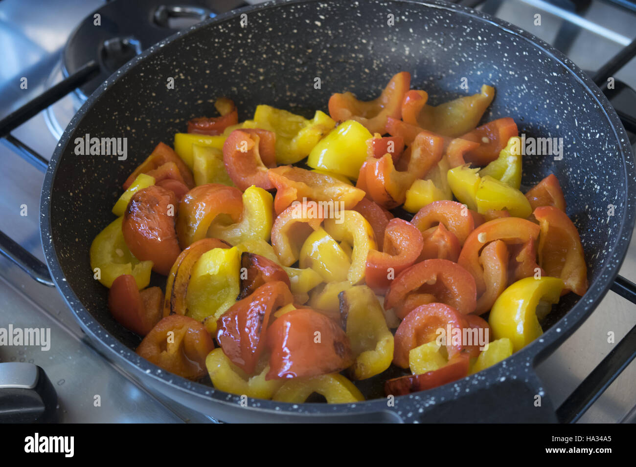 strips of bell peppers fried in pan Stock Photo Alamy