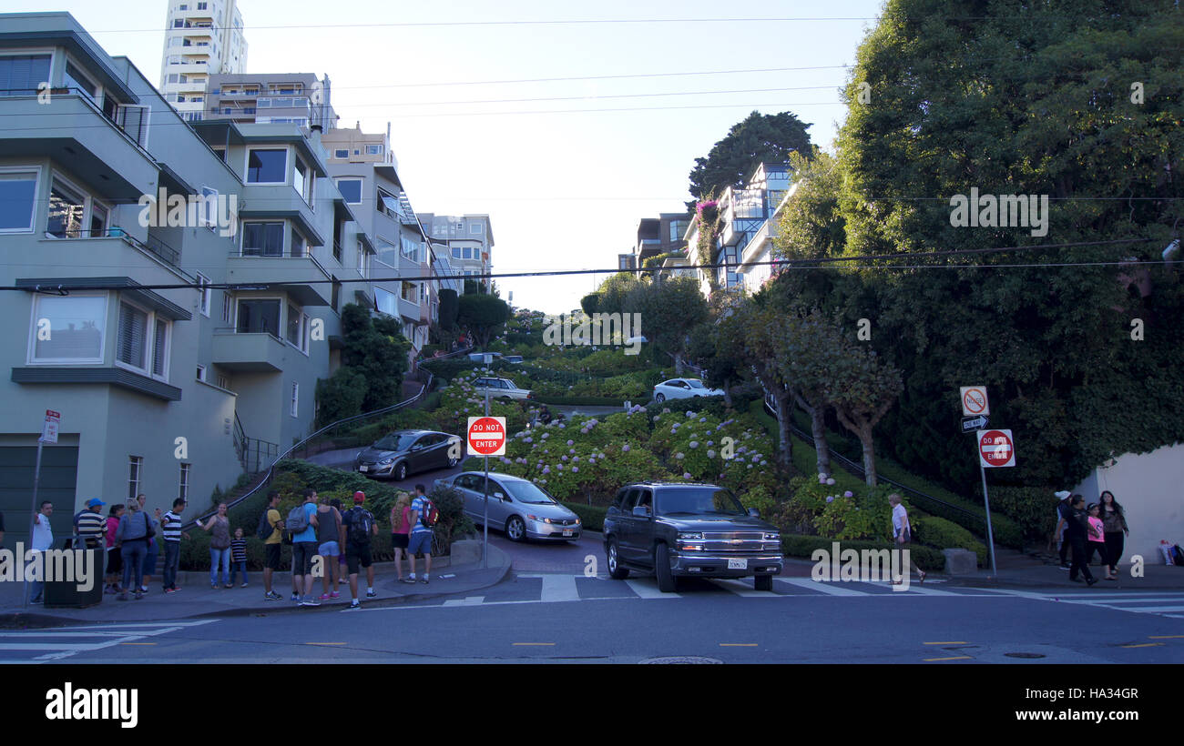 SAN FRANCISCO, USA - OCTOBER 5th, 2014: vehicles drive downhill on Lombard Street, most famous landmark and crookedest in world Stock Photo