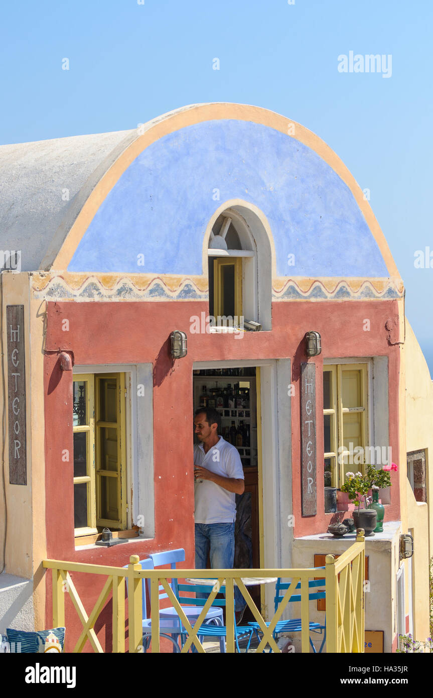 Beautiful souvenir shop and seller in it at Oia town. There are many traditional Greek shops on Santorini island. Stock Photo
