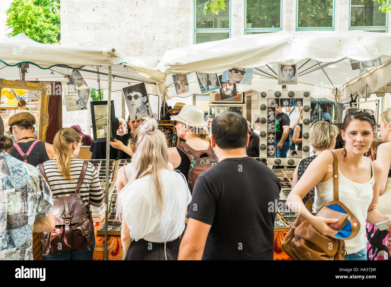 visistors of stuttgart spring flea market in front of a stall selling used eye wear Stock Photo