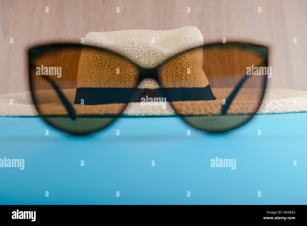 Straw hat and sunglasses on blue background. beach equipment Stock ...