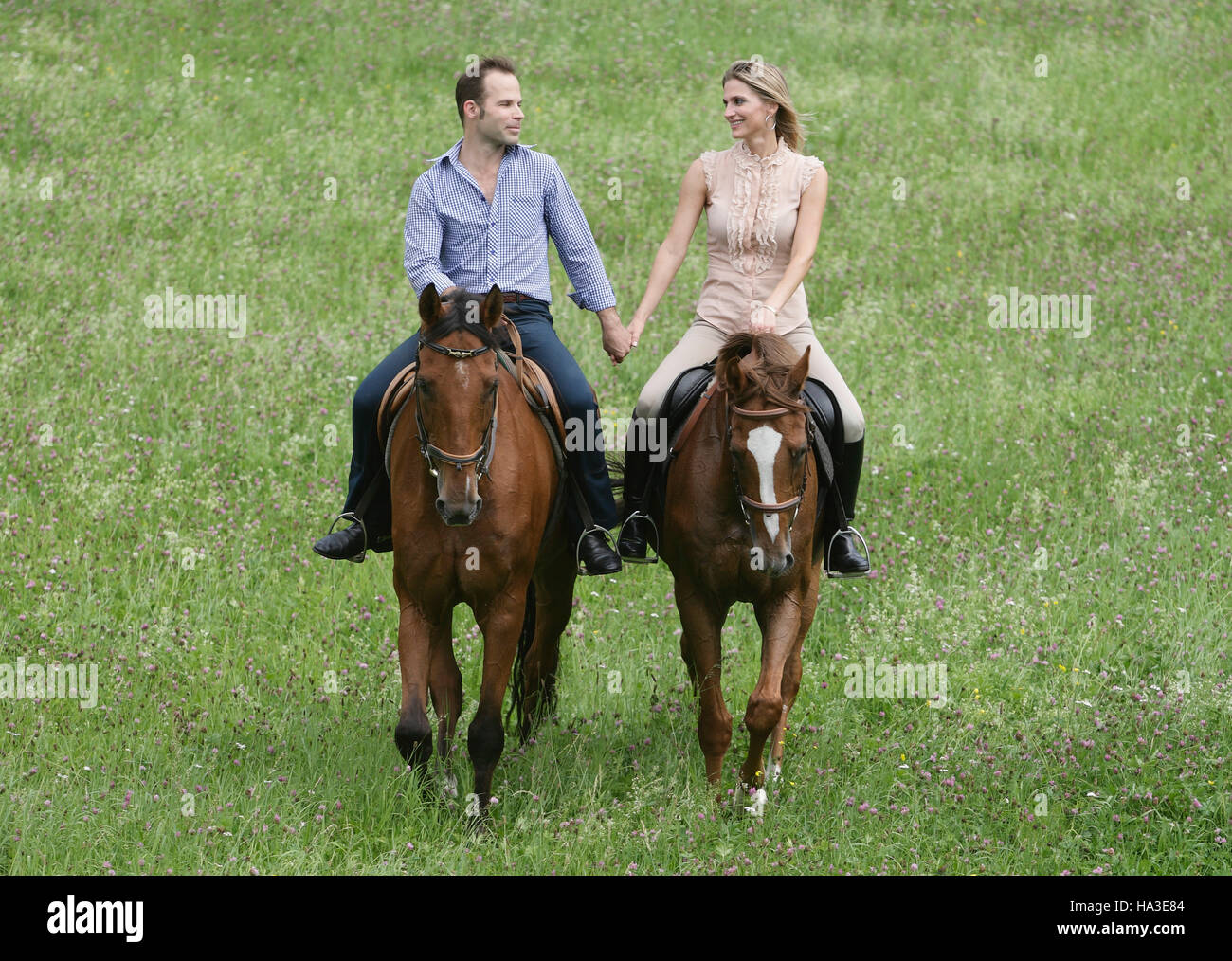 Couples riding horses and holding hands hires stock photography and images Alamy