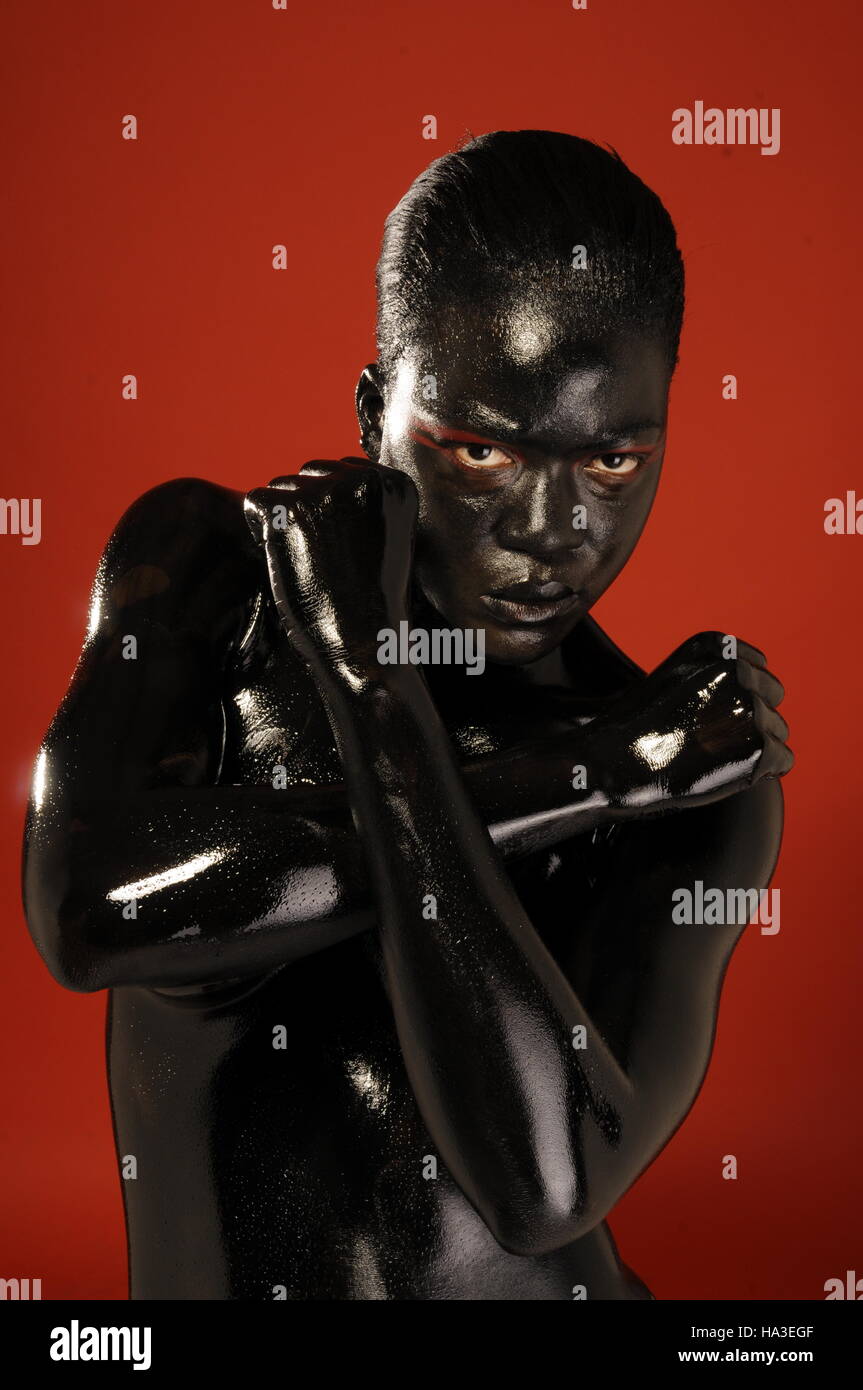 Black model covered in black body paint Stock Photo - Alamy