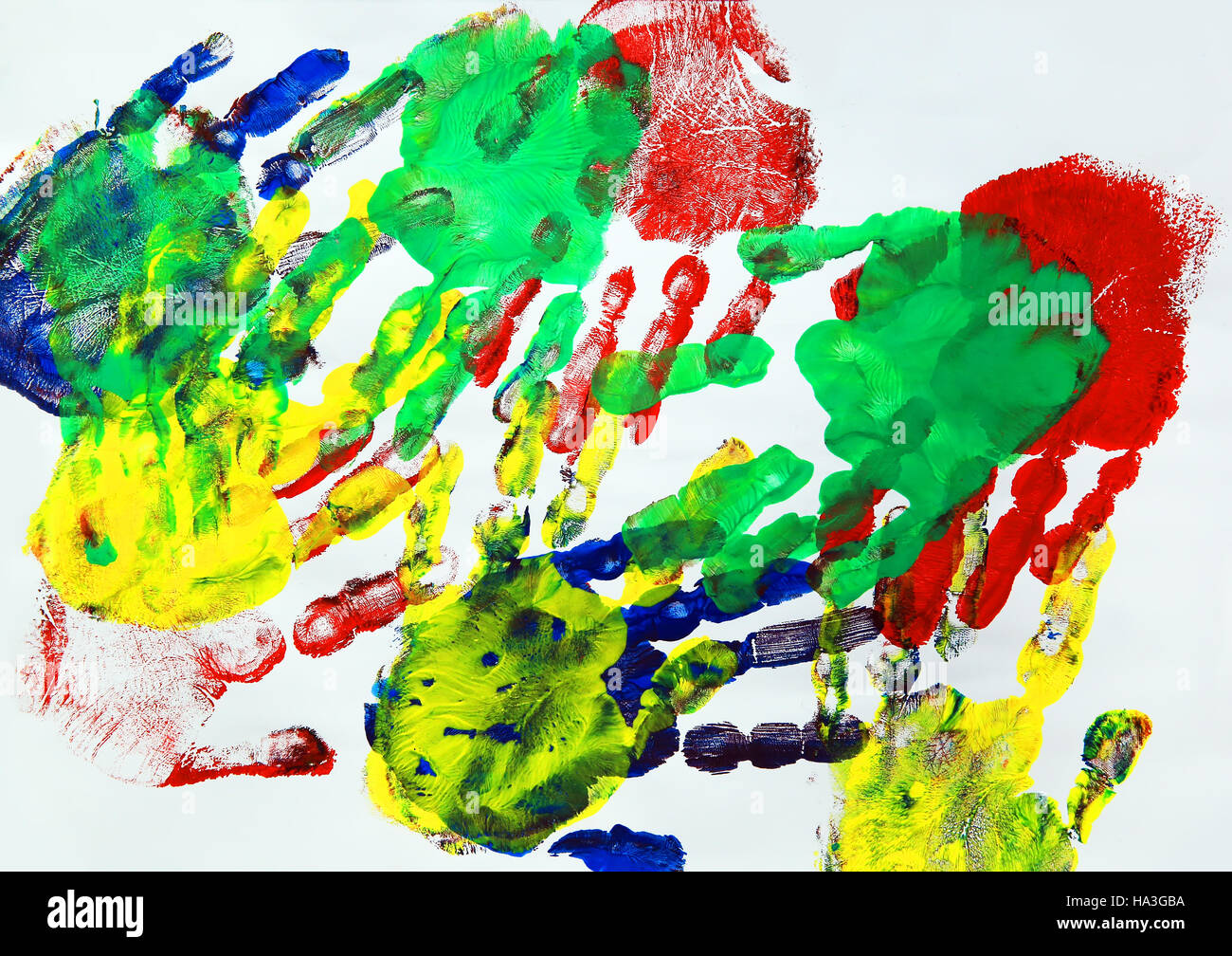 Painting with colorful kids hand prints Stock Photo