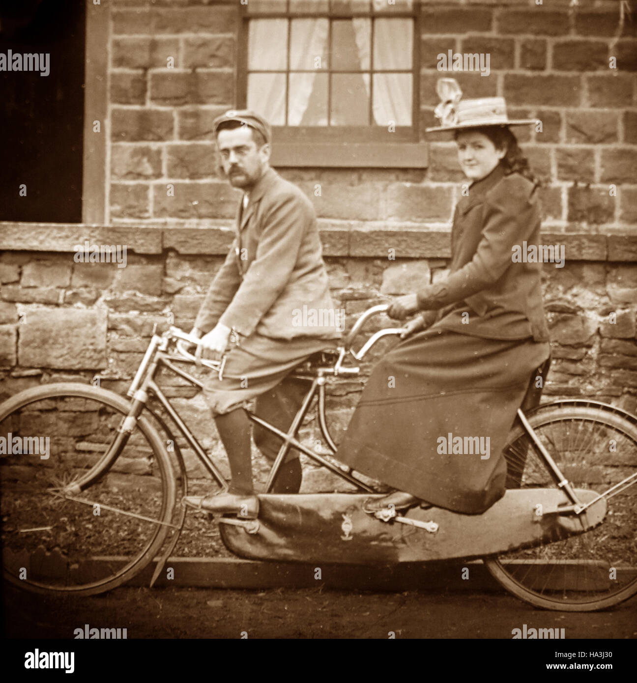 @1900s vintage photo of man and woman on tandem bicycle @1900s vintage photo of man and woman on tandem bicycle